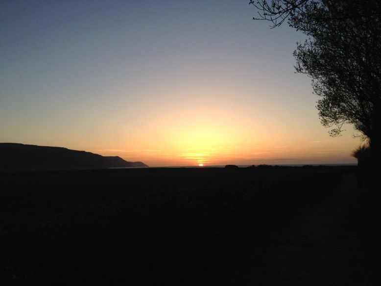 The sun sets over Porlock Bay. Photo by Elke Winzer