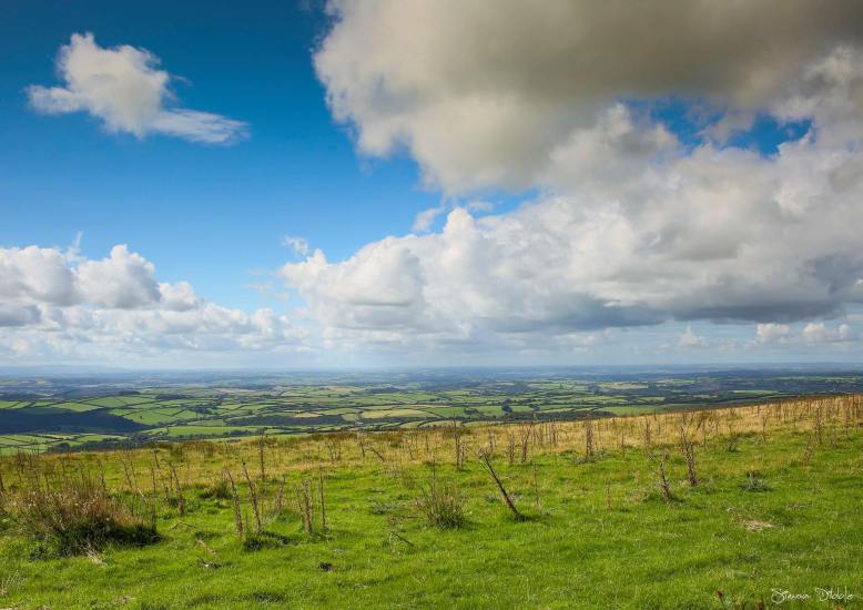On top of the world with expansive views. Looking towards the North Devon Coastline. Photo by Simon Dibble